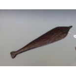 A 19thC Aboriginal wooden spear thrower with carved linear decoration to one side,