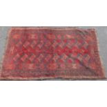 A Turkoman rug on a wine ground 187cm x 110cm