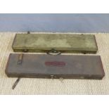 Two indistinctly named canvas and leather side by side double barrelled gun cases both with brass