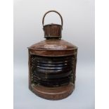 A large copper port ship's navigation lamp,