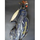 A MacGregor golf bag containing sixteen driver and wedge golf clubs by Wilson, Dunlop, Petron,