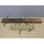 Three canvas and leather gun cases, two with brass fittings,