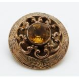 A Victorian brooch with engraved decoration and set with a citrine, 3.3cm, 9.