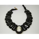 A Victorian jet necklace made up of faceted beads and a cameo centre