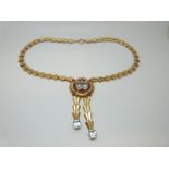 A Tiffany & Co 14k gold necklace set with an emerald cut aquamarine measuring approximately 9ct