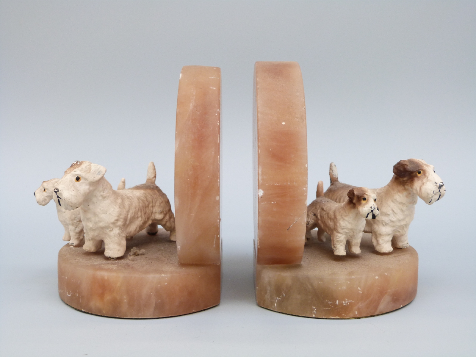 A pair of Art Deco onyx bookends cold painted bronze Sealyham terriers with puppies, H11.