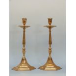 A pair of bronze or similar cast hexagonal candlesticks,