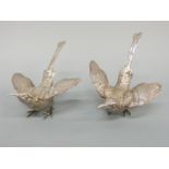 A pair of white metal stylised birds, marked to wings 925 sterling, length 14cm,