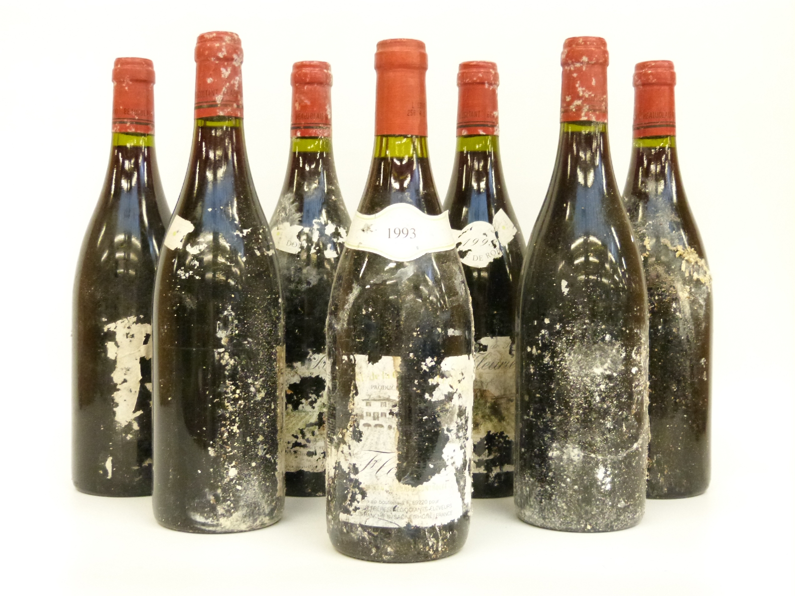 Seven bottles of Fleurie red wine circa 1993 (partial or no labels) all 75cl