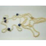 A two strand pearl necklace with a 14ct gold clasp and a pearl necklace set with lapis lazuli beads