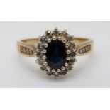 An 9ct gold ring set with a sapphire surrounded by diamonds (size O)