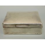 A hallmarked silver cigarette box, marks rubbed,
