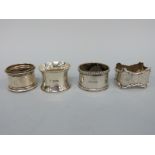 Four various hallmarked silver napkin rings,