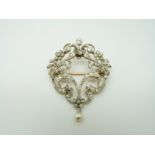 An early 20thC brooch set with diamonds in a floral/ foliate design and a drop pearl, 4.2 x 3.