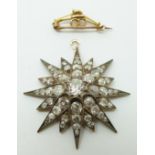 A Victorian star pendant set with a large old mine cut diamond measuring approx 1ct surrounded by