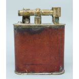A large plated and leather effect table lighter with various patent marks for European countries