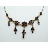 A Victorian necklace set with bohemian cut garnets.