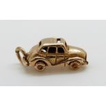 A 9ct gold charm in the form of a car, 4.