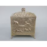 An Indian/Burmese white metal tea caddy with relief decoration of wild animals including elephants,