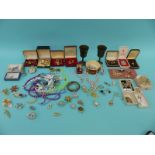 A collection of costume jewellery including brooches, necklaces, beads, Smiths pocket watch,