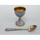 A silver gilt and enamelled egg cup and spoon with impressed 916 and worker's head mark