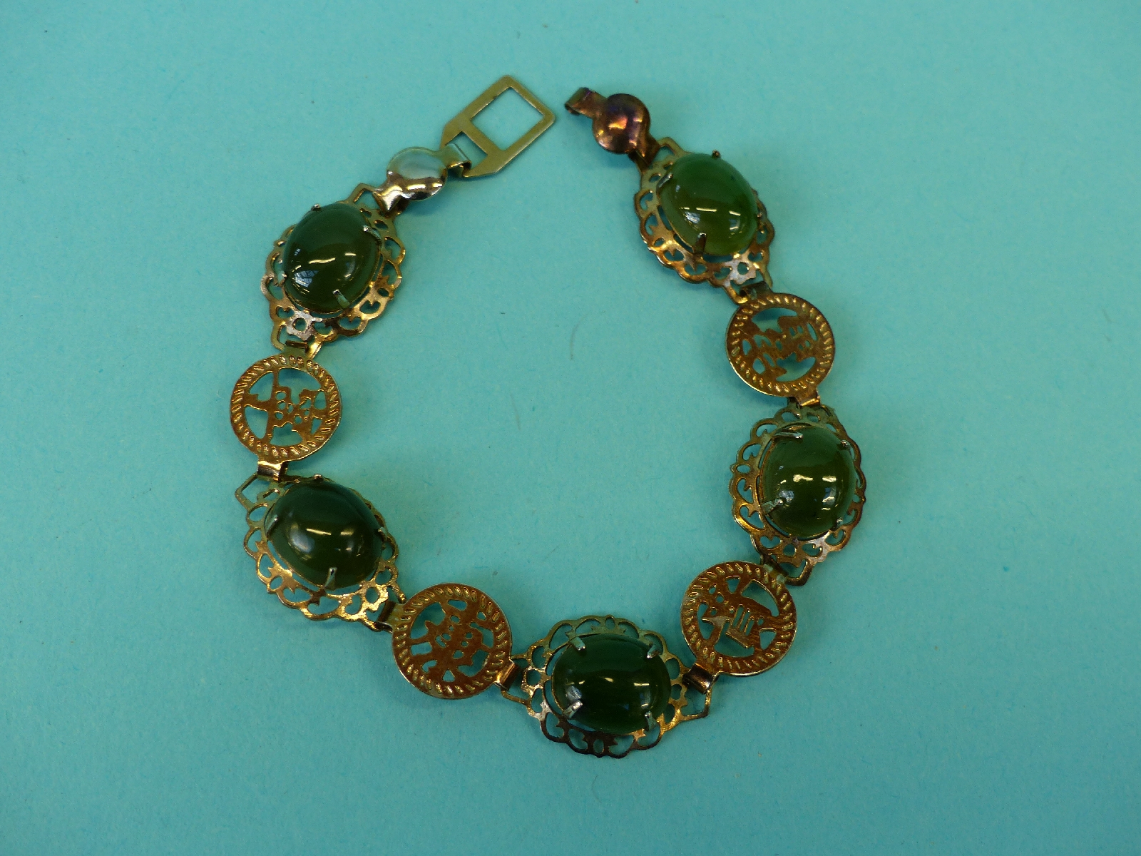 A Chinese bracelet set with nephrite jade cabochons, a jet brooch, plated gate bracelet, - Image 2 of 9