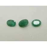 Three oval cut emeralds the largest approximately 1.