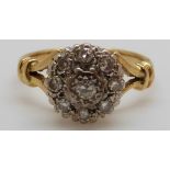 An 18ct gold ring set with diamonds in a cluster,