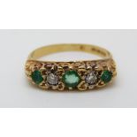 An 18ct gold ring set with diamonds and emeralds (size M)