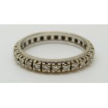 A white metal eternity ring set with diamonds (size L)