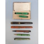 Seven vintage pens and pencils including George Parker green marbled pair,