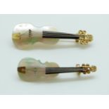 Two brooches in the form of violins set with mother of pearl,