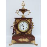 A burgundy marbled and ormolu clock, the Roman dial with gilt bezel and beetle and poker hands,