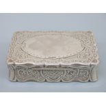 A Victorian hallmarked silver table top snuff box with shaped lid and engraved decoration,