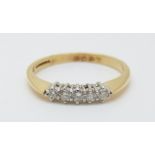 An 18ct gold ring set with five diamonds totalling approximately 0.2ct, 2.