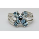 A 9ct white gold ring set with blue topaz in flower cluster (size N)