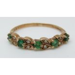 A 9ct gold ring set with a emeralds and diamonds (size N)