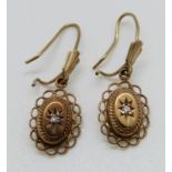A pair of 9ct gold earrings set with diamonds