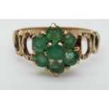 A 9ct gold ring set with an emerald surrounded by diamonds in a cluster (size L)