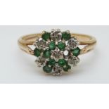 A 9ct gold ring set with emeralds and diamonds in a cluster (size Q)