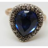 A Victorian ring set with a large pear cut synthetic sapphire of approximately 4.
