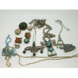 Three Egyptian white metal pendants and chains,