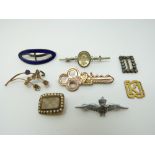 A Victorian mourning brooch, gold plated 21 key brooch, silver brooch, RAF brooch,