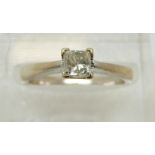 An 18ct white gold ring set with a princess cut diamond of approximately 0.