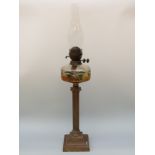 A Victorian cut glass oil lamp with amber and green cut glass reservoir and twin Duplex burner