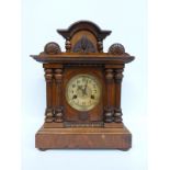 A two train mantel clock in classical design case with Roman ivory coloured chapter ring and gilt