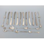 Four various hallmarked silver spoons, weight 31g, a quantity of white metal and other spoons,