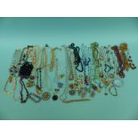 A collection of costume jewellery to include beaded necklaces, brooches, rabbit foot, jet beads,