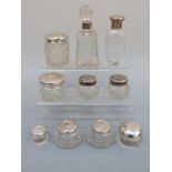 Eight hallmarked silver-topped dressing table jars and two silver-mounted scent bottles