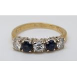 An 18ct gold ring set with alternating sapphires and diamonds, each stone approximately 0.